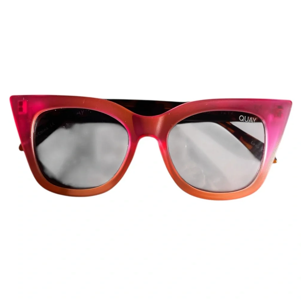 Quay Harper Kids cat-eye sunglasses with coral pink and smoke lenses.